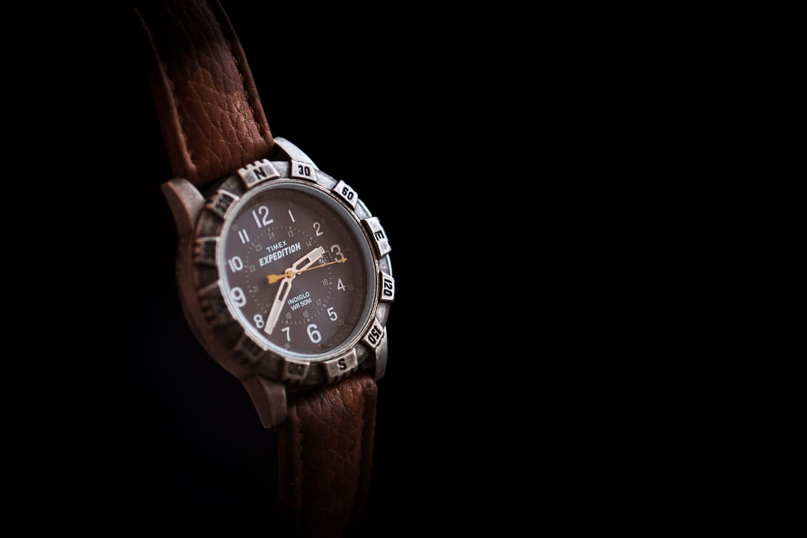 A wristwatch on a brown leather strap